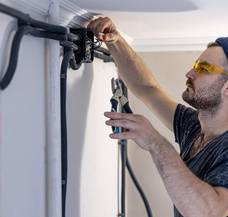 an-electrician-is-mounting-electric-sockets-on-the-2023-11-27-05-06-58-utc (1)