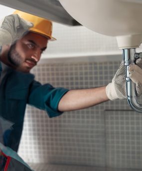 male-plumber-is-repairing-faucet-of-a-sink-at-bath-2024-10-18-08-07-33-utc